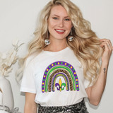 Mardi Gras Rainbow DTF Heat Transfer, woman wearing a T-shirt with a colorful Mardi Gras rainbow design featuring leopard print, purple, green, yellow, and purple fleur-de-lis symbols.