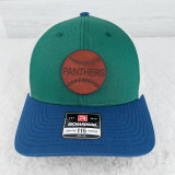 Personalized Leather Baseball Softball Patch, close-up of the patch embroidered on a colorful trucker cap with blue, green, and white panels.