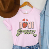 Home Grown Strawberry DTF Heat Transfer, pink T-shirt with strawberry and heart graphic design and the phrase 'Home Grown' printed on it.