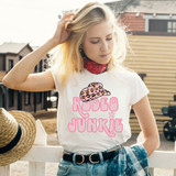 Rodeo Junkie DTF Heat Transfer, a white T-shirt with pink text and a leopard-print cap graphic for a fashionable and trendy look.