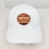 Support Your Local Farmer Leather Patch, white baseball cap with supportive farm-themed leather patch on front.