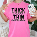 Thick Thighs Thin Patience Leopard DTF Heat Transfer T-Shirt, pink t-shirt with leopard print lettering of the phrase 'Thick Thighs Thin Patience'.