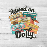 Raised On Dolly Die Cut Sticker, colorful cassette tape themed sticker design with nostalgic text and illustrations.