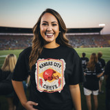 KC Helmet DTF Heat Transfer, a colorful heat transfer patch with the Kansas City Chiefs logo on a woman's black T-shirt at a sports stadium.