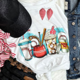 Baseball Latte Screen Print Heat Transfer, detailed image of a heat transfer graphic featuring baseball-themed drinks on a white t-shirt, surrounded by casual apparel including a black cap, striped ribbon, jeans, and leather shoes.