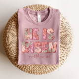 He Is Risen Screen Print Heat Transfer, Pink T-shirt with floral text design for Easter celebration.
