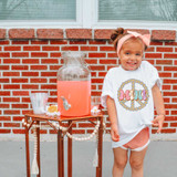 Mini Peace Retro DTF Heat Transfer, small retro peace sign graphic on a child's white t-shirt.