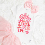Man I Feel Like I'm 1 DTF Heat Transfer, white baby onesie with pink lettering and leopard print cap design.