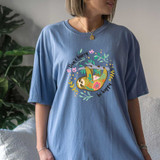 Don't Hurry Be Happy DTF Heat Transfer, colorful sloth design on a blue T-shirt.