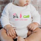 Daddy's Little Caddy DTF Heat Transfer, printed design featuring a golf cart, golf bag, and a tank, with the text Daddy's Little Caddy on a baby's white shirt.