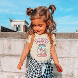 Mini Spring Drinks DTF Heat Transfer, image of a young girl wearing a t-shirt with a colorful spring-themed drink design featuring a jar, flowers, and strawberries.