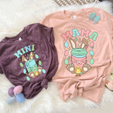 Mama Easter Drink DTF Heat Transfer, colorful Easter-themed designs on pink and purple T-shirts featuring bunny, chick, and beverage illustrations.