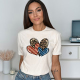 Leopard Americana Heart Trio DTF Heat Transfer, featuring a design of three hearts with American flag, leopard, and striped patterns on a woman's t-shirt.