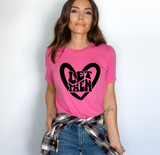 Let Them DTF Heat Transfer, woman wearing a pink T-shirt with a black heart design and 'Let Them' text in the center.