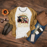 Oh Look Another Crazy Heifer sublimation transfer T-shirt, featuring cute cows with floral accents and retro rainbow background, displayed on a casual outfit with accessories.
