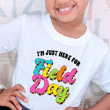 I'm Just Here For Field Day DTF Heat Transfer T-shirt, colorful playful text design on a white shirt.