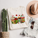 Cinco De Mayo Lattes DTF Heat Transfer, colorful illustration of festive cactus, guitars, roses, and traditional drinks on a white t-shirt, with a cactus plant, pink hat, denim shorts, and sunglasses nearby.