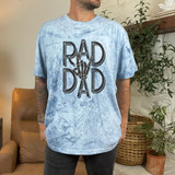 Rad Dad Skeleton Hand DTF Heat Transfer, black graphic design of a skeleton hand making the rock and roll gesture on a blue textured T-shirt.
