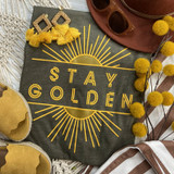 Stay Golden PUFF Screen Print Heat Transfer, yellow and black graphic design with radiating lines and 'Stay Golden' text on dark fabric background.