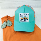 Stay Wild Roam Free Embroidered Patch, turquoise baseball cap with colorful mesh back and outdoor scenery design.