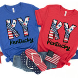 KY Stars & Stripes DTF Heat Transfer, American flag-themed design on red and blue T-shirts with the words "KY Kentucky" and patriotic accessories.