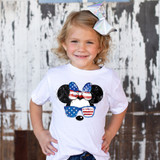 Patriotic Mouse Bow DTF Heat Transfer, a girl wearing a white t-shirt with patriotic-themed mouse graphic, sunglasses, and bow accessories.