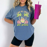 Find Me Under The Palms Retro DTF Heat Transfer, graphic design with palm trees, tropical drink, and floral elements on a blue t-shirt.