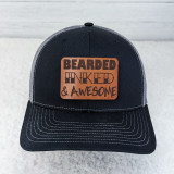 Bearded, Inked & Awesome Leather Hat Patch, close-up of a black and gray trucker hat featuring a brown leather patch with bold lettering and design.