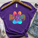Rescue All The Dogs DTF Heat Transfer, colorful graphic T-shirt with text and dog paw design on purple fabric.