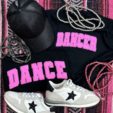 Dancer Pink Youth Screen Print Heat Transfer, black t-shirts with pink DANCER heat transfer design, paired with gray and black sneakers, pink and gray pearl necklaces, and a black cap with glitter, on a pink and black striped background.