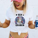 Ben Drankin DTF Heat Transfer, humorous patriotic graphic T-shirt with a caricature of Benjamin Franklin wearing American flag glasses and headband, holding a beer glass.