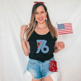 1776 DTF Heat Transfer, woman wearing a black tank top with patriotic red, white, and blue design, holding an American flag, patriotic summer outfit.