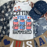 Getting Star Spangled Hammered DTF Heat Transfer, patriotic-themed t-shirt with cans decorated in American flag colors, surrounded by Americana accessories.