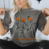 Let's Get Halloweird DTF Heat Transfer, Halloween-themed sweatshirt featuring skeletons with pumpkin heads dancing and the phrase 'Let's Get Halloweird' in orange text.