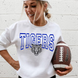 Tigers Royal DTF Heat Transfer, a detailed black and white tiger head design with the word 'TIGERS' in bold blue outline letters on a white sweatshirt.