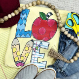 LOVE Teaching Screen Print Heat Transfer, colorful handmade artwork spelling 'LOVE' with decorated letters and a strawberry, surrounded by craft and fashion accessories.