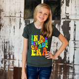 In My Seventh Grade Era DTF Heat Transfer, colorful graphic design on a young girl's t-shirt, showcasing a cheerful and vibrant back-to-school theme.