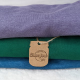 Custom Cardstock Mason Jar Tags, image of stacked colorful t-shirts with a brown paper tag attached by a string.