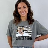 Try That In A Small Town Black/White Flag DTF Heat Transfer, woman wearing gray T-shirt with a printed design of a man in a cowboy hat and the phrase 'Try That In A Small Town'.