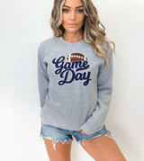 Navy Game Day Football Chenille Patch, woman wearing a gray sweatshirt with 'Game Day' and a football graphic embroidered on the front.