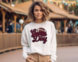 Maroon Game Day Football Chenille Patch, a woman wearing a white sweatshirt with a maroon football patch and the words 'Game Day' embroidered on it.