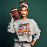 Friday Nights Stadium Lights DTF Heat Transfer, graphic sweatshirt with colorful text and football design for sports fans.