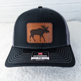 Moose Leather Hat Patch, black trucker cap with brown leather patch featuring a moose silhouette.