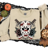 Horror Floral DTF Heat Transfer, horror-themed graphic design with a blood-splattered hockey mask, surrounded by roses and crossed knives.