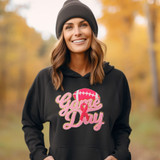 Gold Glitter Breast Cancer Game Day Chenille Patch, close-up of the patch on a person's black hoodie with sports-themed design and pink and gold lettering.
