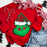 Grouchy Green Guy Chenille Patch, Christmas-themed green patch with Star and Santa hat design on red sweatshirt.