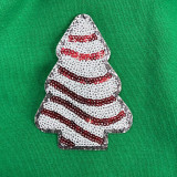 Mini Snack Cake Sequin Patch, decorative patch with white, red, and black sequins creating a snack cake design on green fabric background.