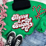 RED Merry & Bright Sequin Chenille Patch, festive holiday embroidered patch on green sweater with Christmas accessories.