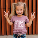 TK Typography WHITE DTF Heat Transfer product, white heat transfer design on a lilac child's t-shirt, girl smiling and showing peace signs.