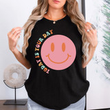 Today Is Your Day DTF Heat Transfer, a pink smiley face design with colorful text on a black t-shirt worn by a woman.